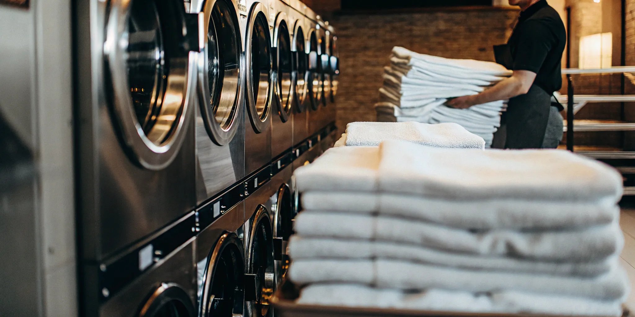 Clean medical laundry folded and stacked in Babylon facility.